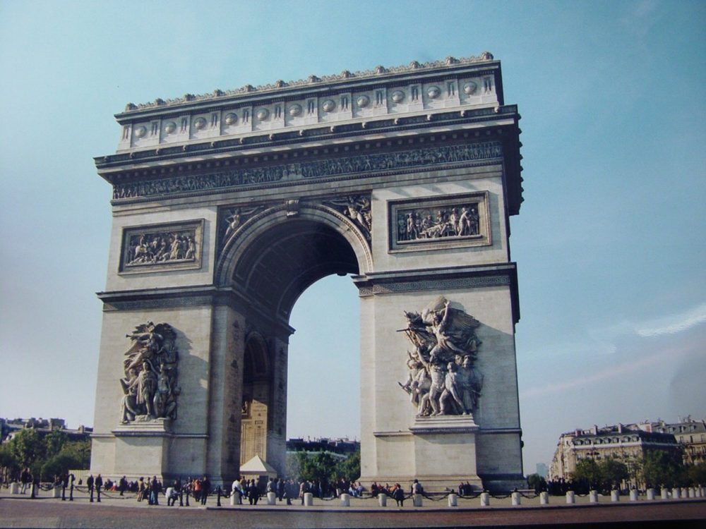 The Arc de Triomphe in Paris, with large sculpted groups on its pillars.