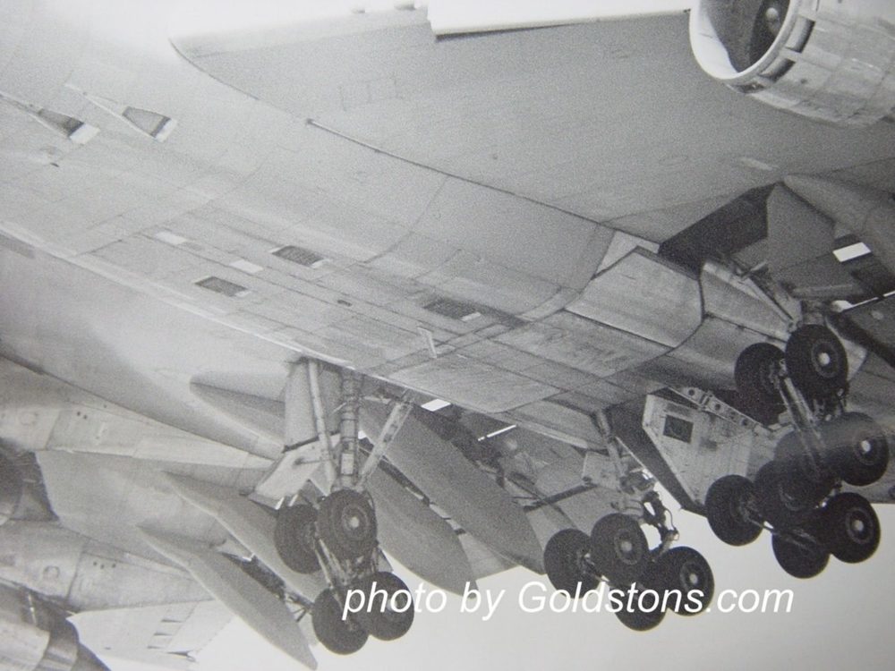 Boeing 747 main landing gear extended: four trucks of four wheels each.